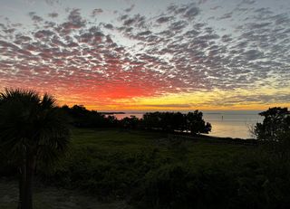 The sun setting over the ocean.