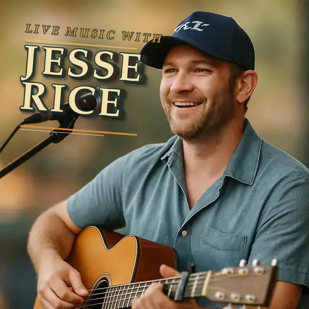 Smiling man in cap playing acoustic guitar on stage.