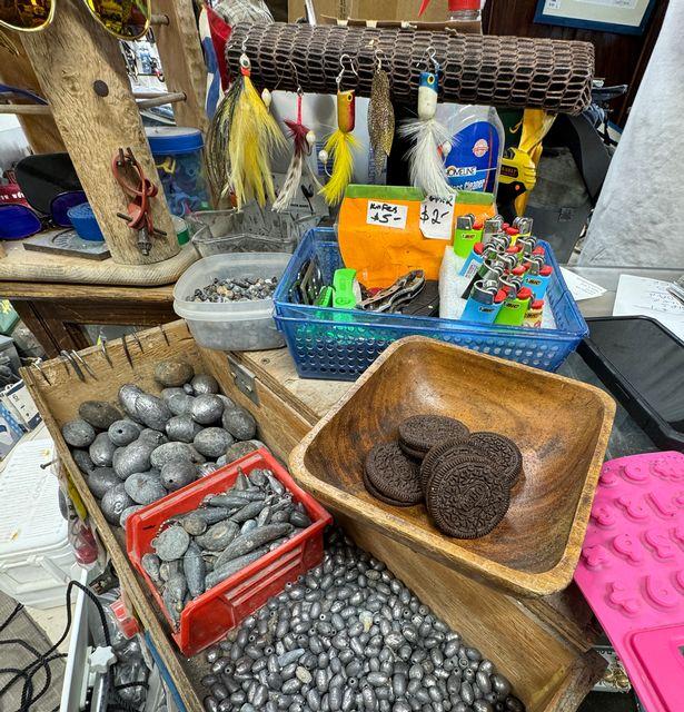 Variety of fishing sinkers and tackle items on a cluttered counter.