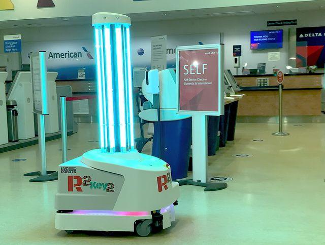 Self-service robot in an airport terminal near check-in counters.
