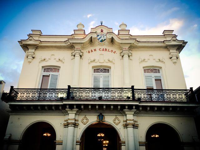 Historic building with intricate facade and balcony under a blue sky.