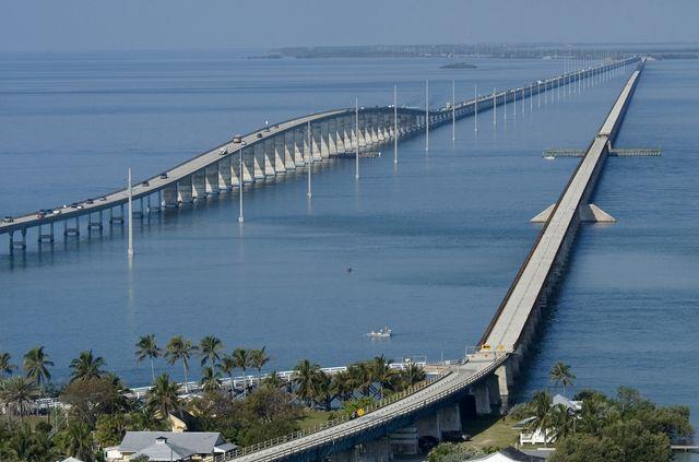 Long bridge stretching across calm blue waters with distant islands.