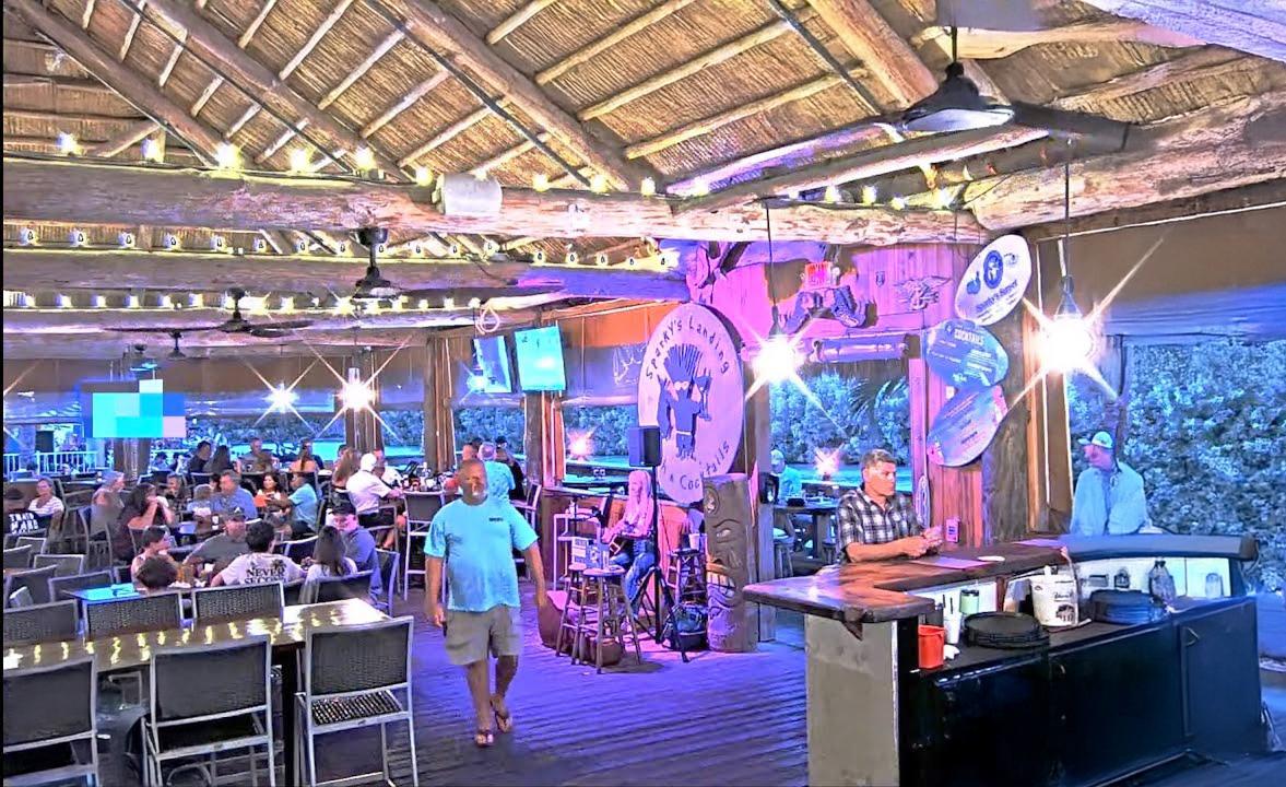 Tropical restaurant interior with ambient lighting and a lively atmosphere.