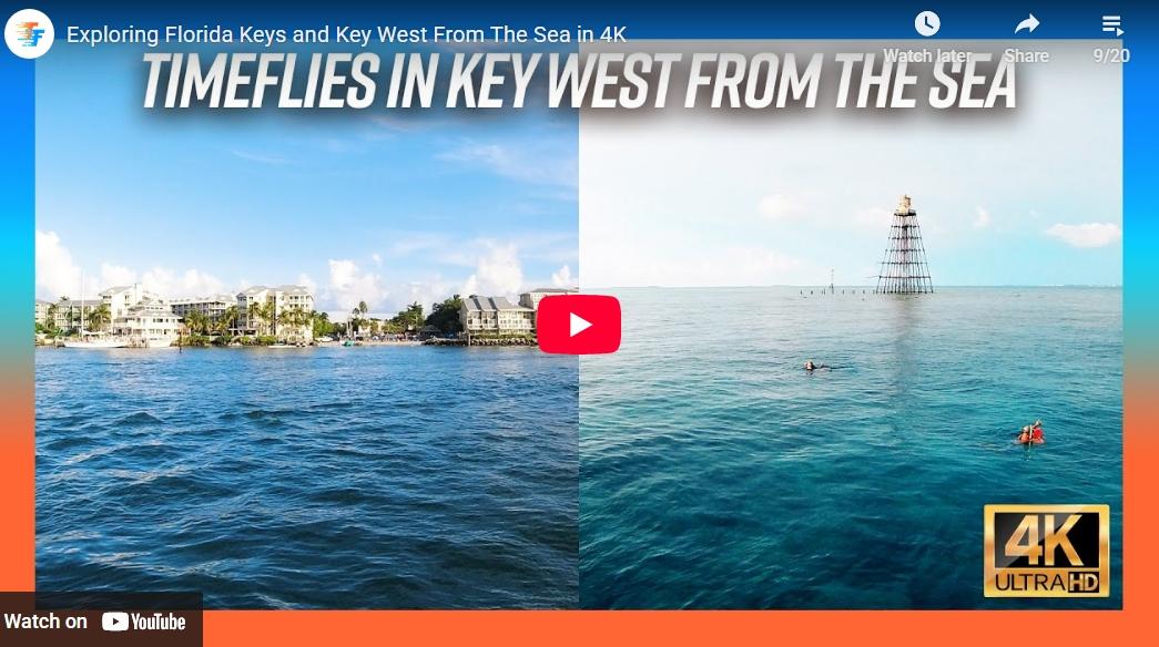 Split ocean view; city shoreline on left, open sea with lighthouse on right, YouTube play button center.