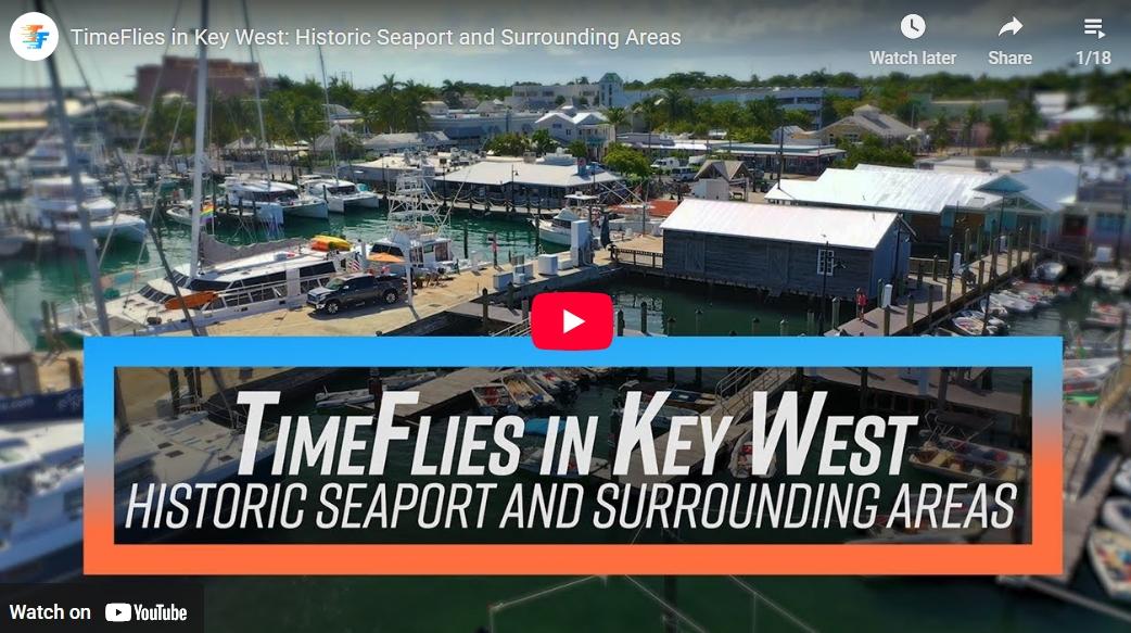 Key West harbor with boats and buildings under a blue sky.