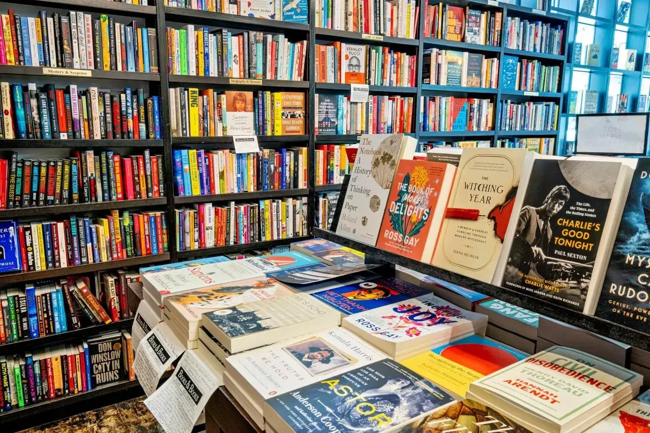 A bookstore with shelves and tables full of colorful books.