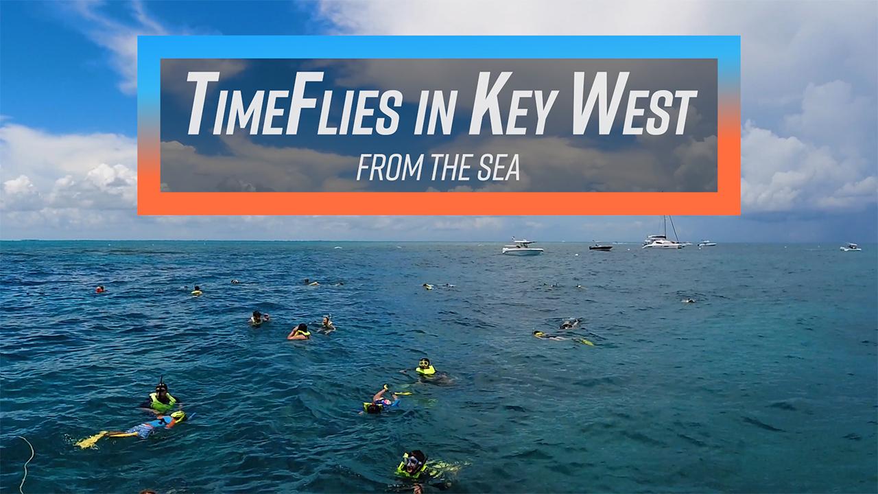 Snorkelers in the ocean under a cloudy sky near Key West.