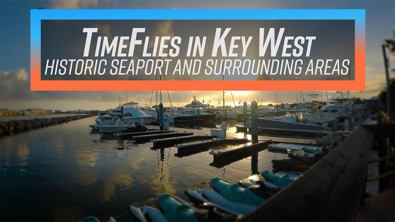 Key West seaport at sunset with docked boats and calm water.