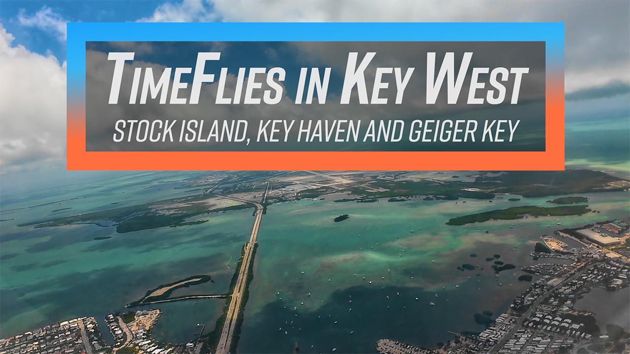 Aerial view of Key West, turquoise waters, and distant islands.