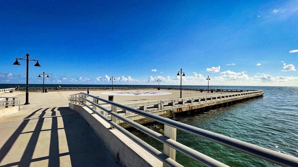 Seaside pier under a clear blue sky.