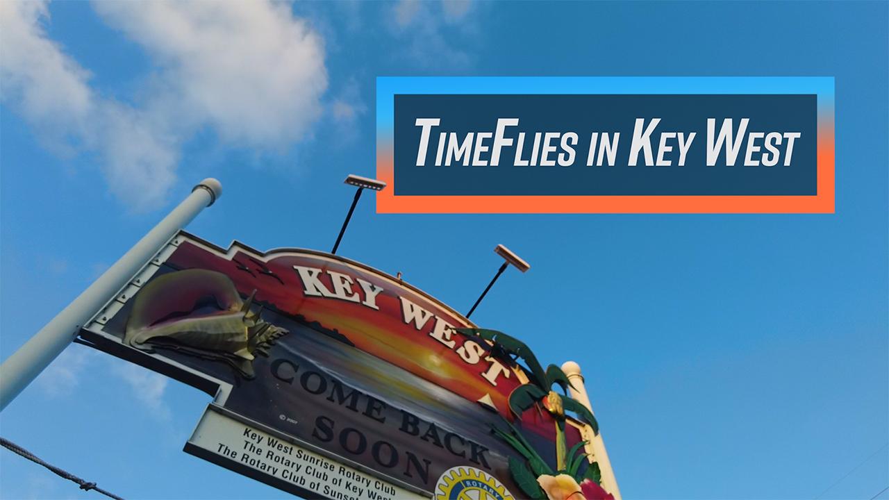 Colorful Key West sign against a bright blue sky.