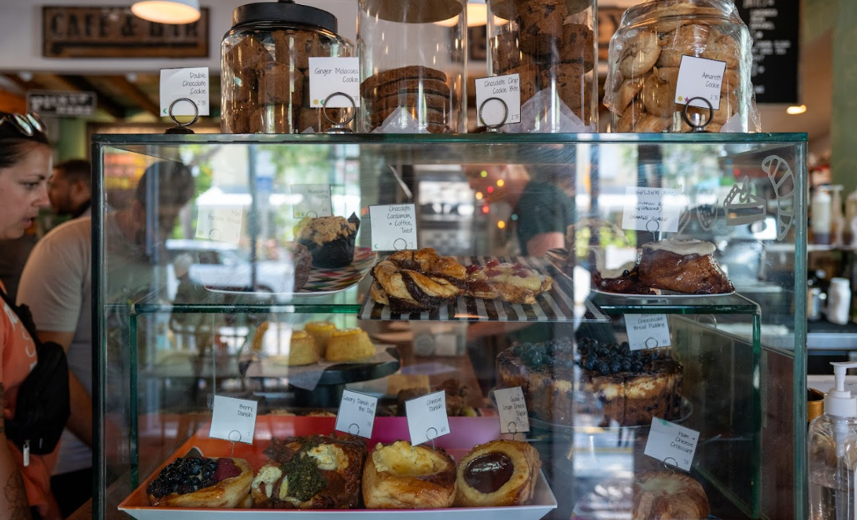 Bakery display with assorted pastries and labeled jars.
