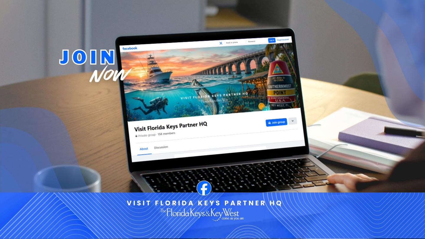 Laptop on table showing a colorful Facebook page, with books nearby.