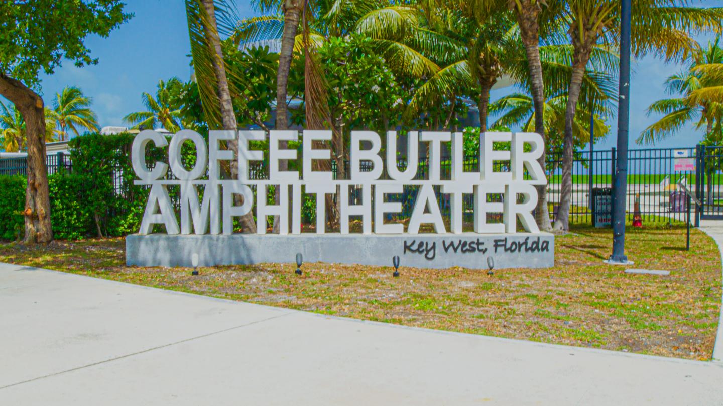 Coffee Butler Amphitheater sign with palm trees in the background.