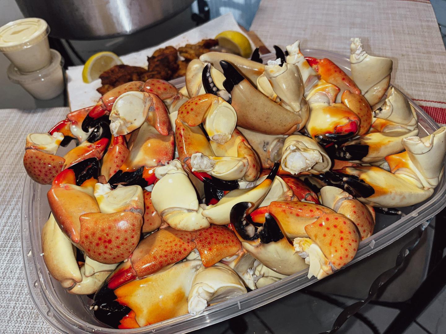 Seafood boil platter with crab, mussels, shrimp, corn, and potatoes.