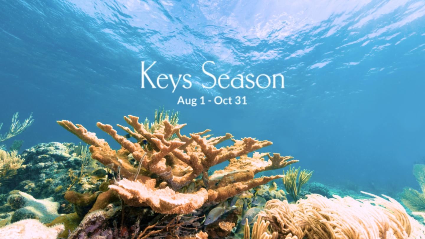Keys Season logo over a coral reef beneath clear blue water.