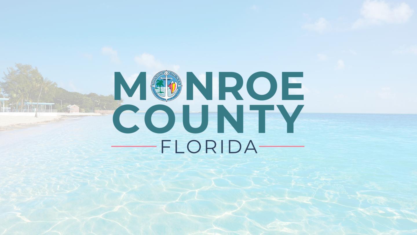 Monroe County Florida logo over a turquoise ocean and beach background