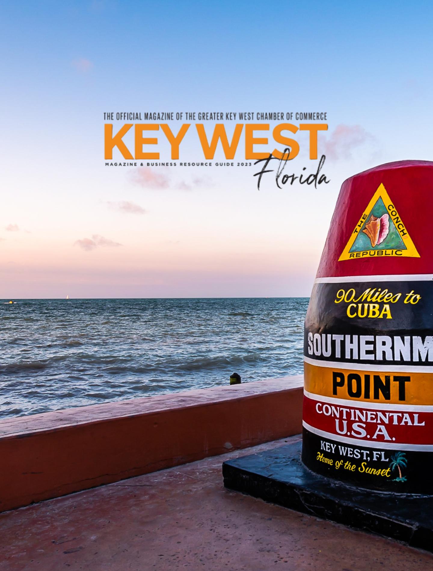 Key West Florida sign beside the ocean at sunset