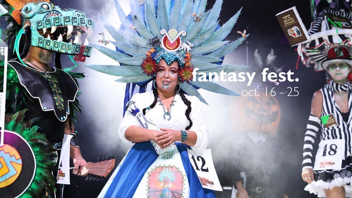 Cosplayer in blue feathered headdress poses at Fantasy Fest.