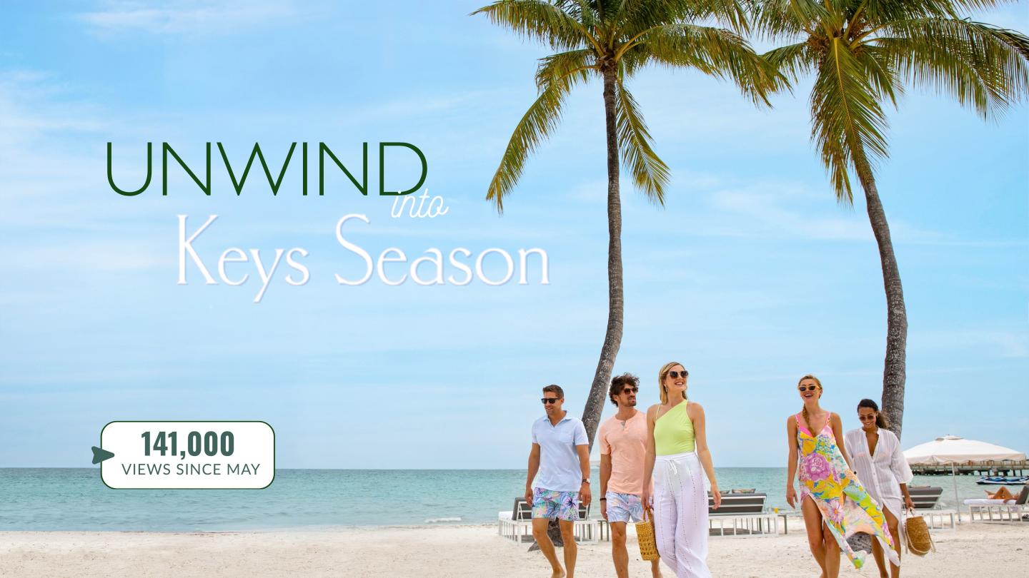 UNWIND Key Season promotion with family walking on a tropical beach.
