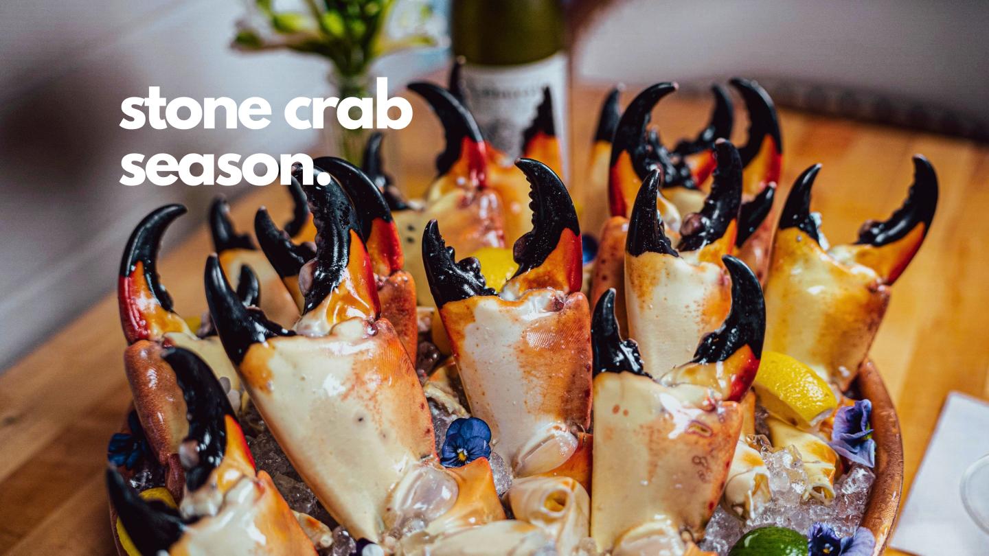 Stone crab claws served on ice with lemon wedges and dipping sauce.