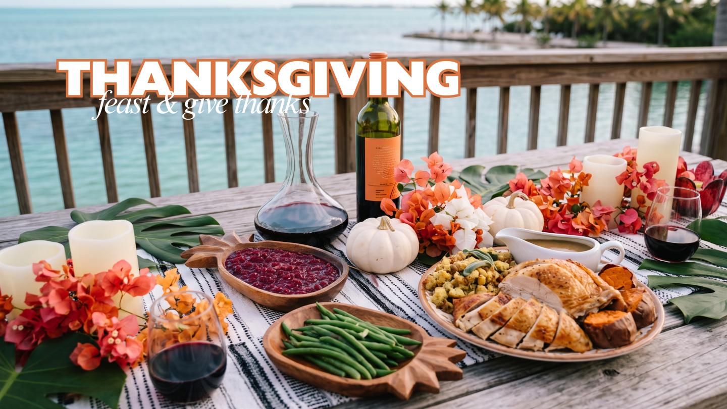 Thanksgiving feast on a table with turkey, vegetables, pies, and autumn flowers